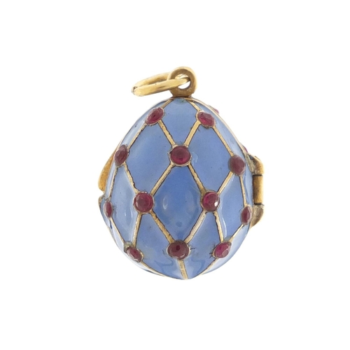 3374 - Russian silver gilt and enamel egg pendant, set with garnets, 2.6cm in length, 6.4g