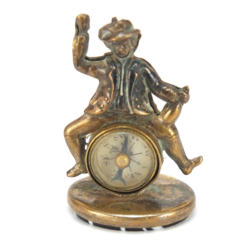 3863 - Gilt metal and agate compass fob in the form of a merry gentleman, 3cm high