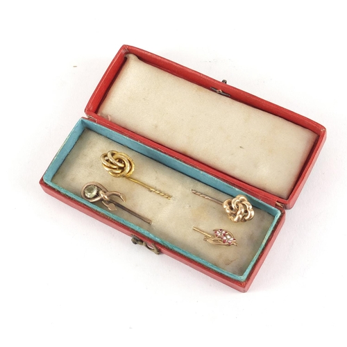 3225 - Three Victorian unmarked gold tie pins and one other enamelled with flowers, the largest 7cm in leng... 