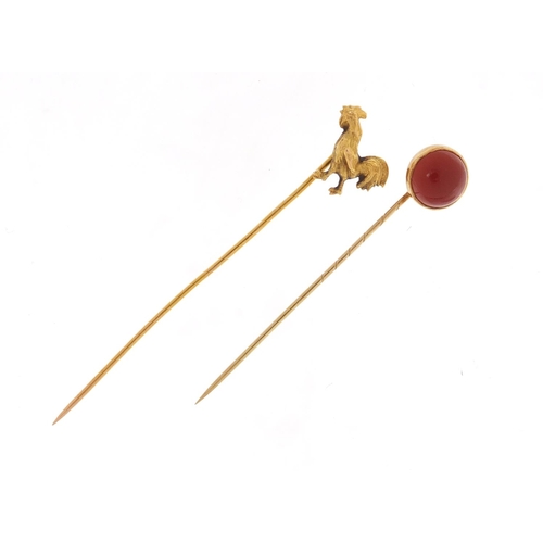 3763 - Two Victorian unmarked gold tie pins including a cockerel and one set with a cabochon carnelian, the... 