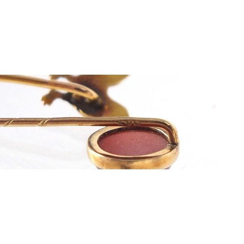 3763 - Two Victorian unmarked gold tie pins including a cockerel and one set with a cabochon carnelian, the... 