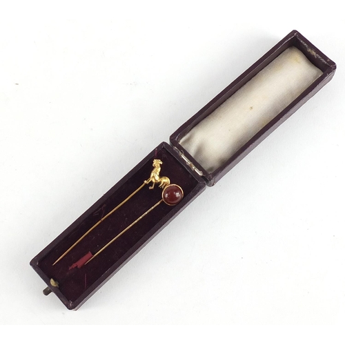 3763 - Two Victorian unmarked gold tie pins including a cockerel and one set with a cabochon carnelian, the... 