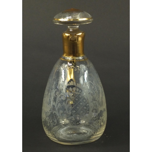 3920 - Continental glass decanter with gilt handle etched with a stag, buildings and flowers, 22.5cm high