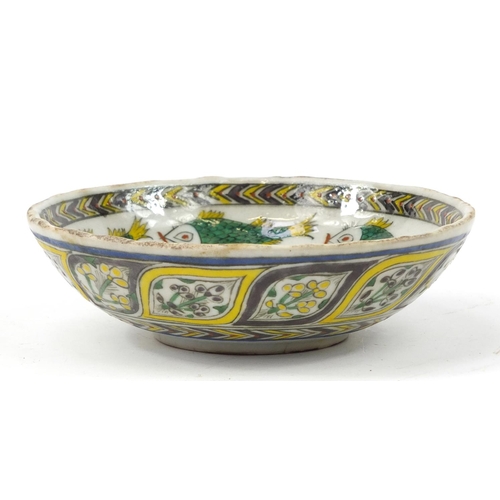 3827 - 18th century Turkish Kutahya pottery bowl hand painted with fish and flowers, 16.5cm in diameter