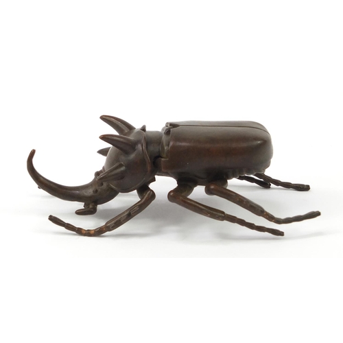 3388 - Large Japanese patinated bronze beetle with articulated wings, impressed character marks to the base... 