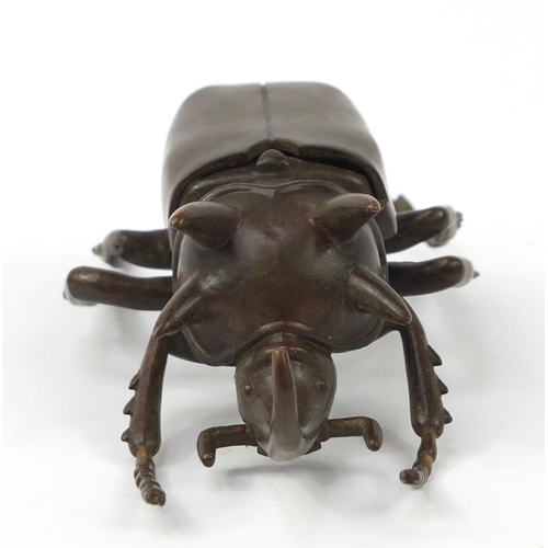 3388 - Large Japanese patinated bronze beetle with articulated wings, impressed character marks to the base... 