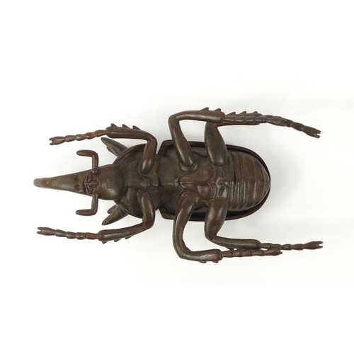 3388 - Large Japanese patinated bronze beetle with articulated wings, impressed character marks to the base... 