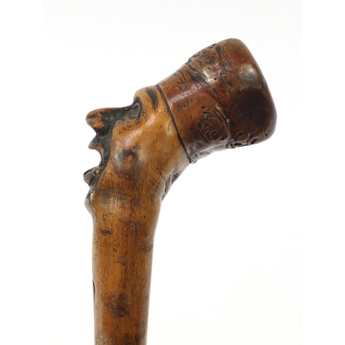 3446 - Folk Art naturalistic walking stick with carved figural pommel, 96cm in length