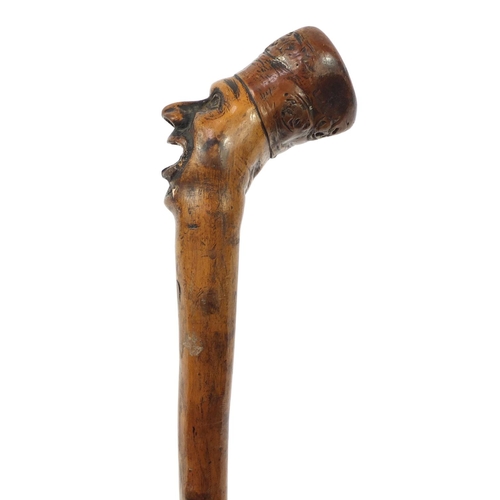 3446 - Folk Art naturalistic walking stick with carved figural pommel, 96cm in length