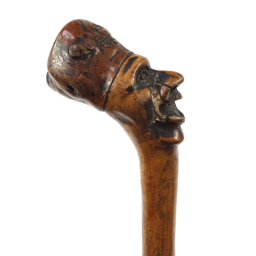 3446 - Folk Art naturalistic walking stick with carved figural pommel, 96cm in length