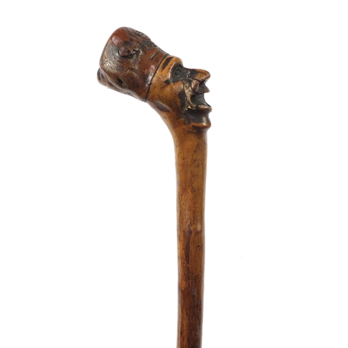 3446 - Folk Art naturalistic walking stick with carved figural pommel, 96cm in length