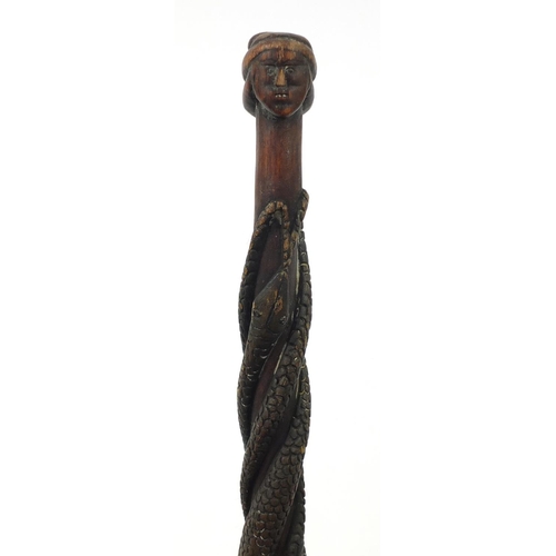 3844 - Tribal interest walking stick with figural pommel, carved with serpents, 92cm in length