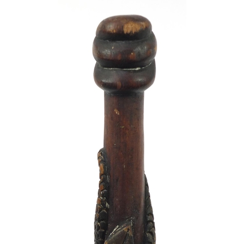 3844 - Tribal interest walking stick with figural pommel, carved with serpents, 92cm in length