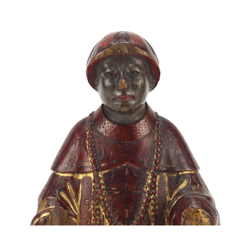 3562 - Antique Chinese red lacquered wood carving of a man wearing a robe, 24cm high