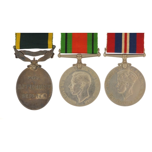 3521 - British military World War II three medal group including a George V Territorial Efficiency medal aw... 