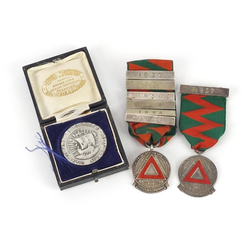 3247 - Two silver and enamel National Safety First Association jewels and a silver London Athletic Shipping... 