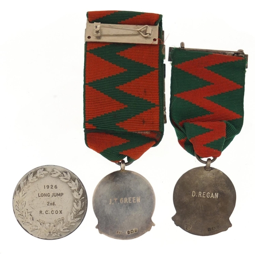 3247 - Two silver and enamel National Safety First Association jewels and a silver London Athletic Shipping... 