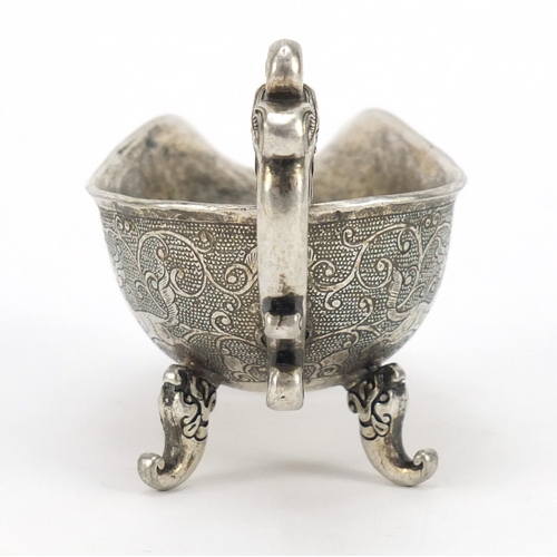 3568 - Chinese silver coloured metal sauce boat, decorated with mythical beasts, character marks to the bas... 