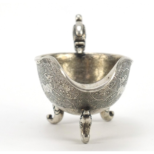 3568 - Chinese silver coloured metal sauce boat, decorated with mythical beasts, character marks to the bas... 