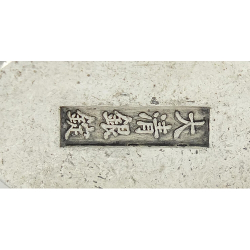 3569 - Chinese silver coloured metal scroll weight, impressed character marks, 6.5cm in diameter