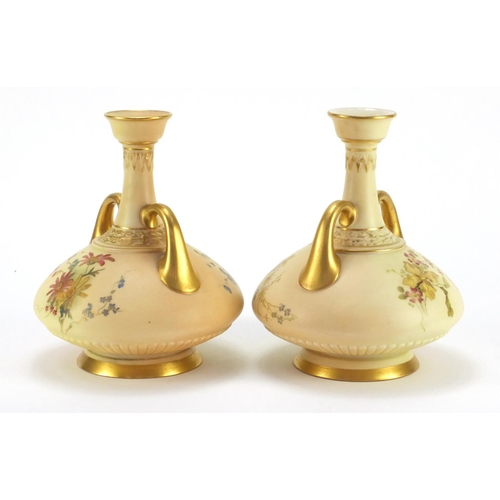 3045 - Pair of Royal Worcester blush ivory vases with twin  handles, each decorated with flowers, numbered ... 