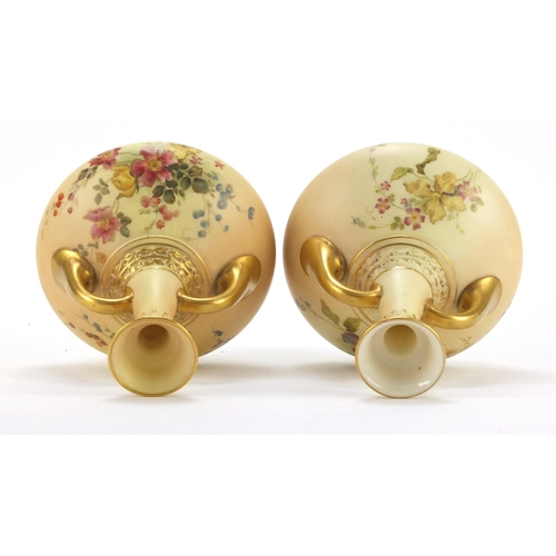 3045 - Pair of Royal Worcester blush ivory vases with twin  handles, each decorated with flowers, numbered ... 