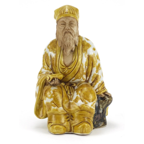 3213 - Chinese porcelain figure of seated Emperor holding a scroll, hand painted with Daoist emblems, impre... 