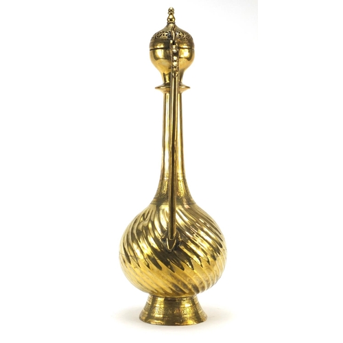 3839 - Islamic brass water pot with writhen body, 49.5cm high