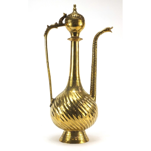 3839 - Islamic brass water pot with writhen body, 49.5cm high