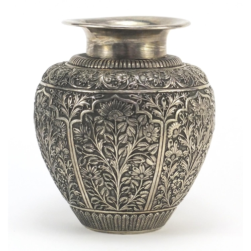 4136 - Indian silver coloured metal vase embossed and engraved with panels of flowers, 17.5cm high