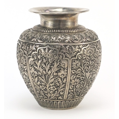4136 - Indian silver coloured metal vase embossed and engraved with panels of flowers, 17.5cm high