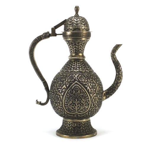 4133 - Indian silver coloured metal wine ewer embossed and engraved with flowers, 36cm high