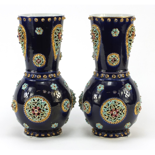 3914 - Large pair of continental porcelain vases with reticulated roundels, hand painted with flowers, poss... 