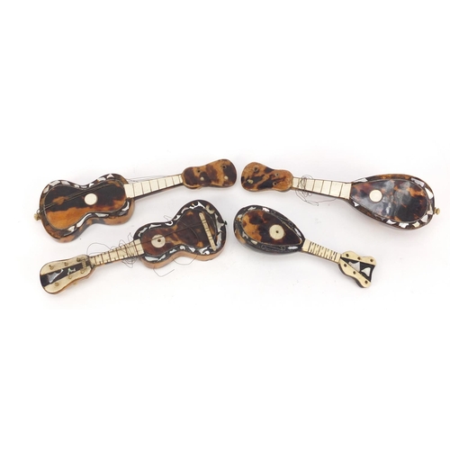 3994 - Four tortoiseshell and mother of pearl musical instruments comprising two guitars and two mandolins,... 