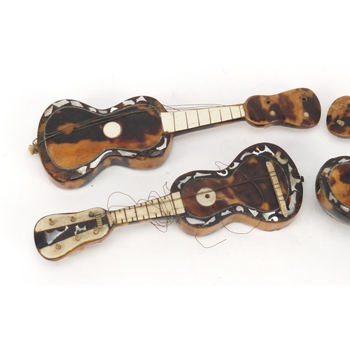 3994 - Four tortoiseshell and mother of pearl musical instruments comprising two guitars and two mandolins,... 