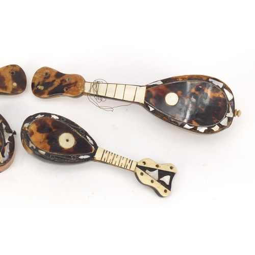 3994 - Four tortoiseshell and mother of pearl musical instruments comprising two guitars and two mandolins,... 