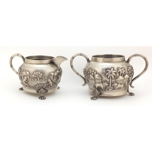 3838 - Indian silver coloured metal silver coloured bowl and milk jug embossed with farmers and cattle, the... 