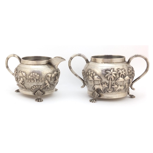 3838 - Indian silver coloured metal silver coloured bowl and milk jug embossed with farmers and cattle, the... 