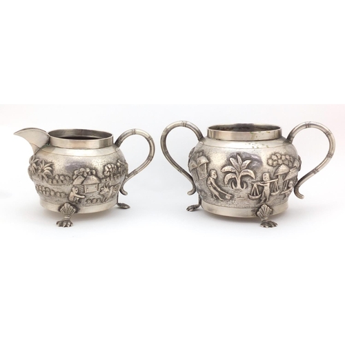 3838 - Indian silver coloured metal silver coloured bowl and milk jug embossed with farmers and cattle, the... 