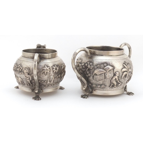 3838 - Indian silver coloured metal silver coloured bowl and milk jug embossed with farmers and cattle, the... 