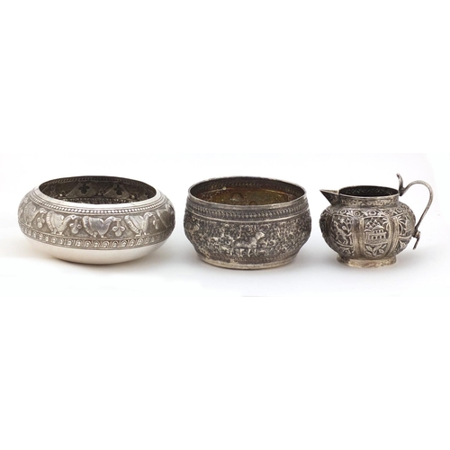 3136 - Two Indian silver bowls and a jug, each embossed with wild animals, the largest 12cm in diameter, 31... 