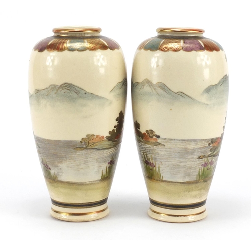 3215 - Pair of Japanese Satsuma pottery vases hand painted with figures in landscapes, character marks to t... 