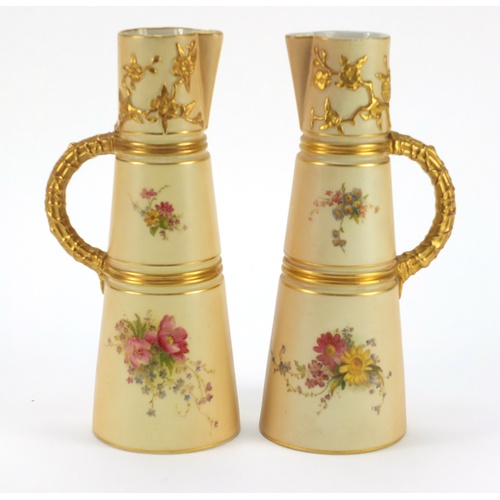 3274 - Pair of Royal Worcester blush ivory jugs with tapering bodies, each hand painted and gilded with flo... 