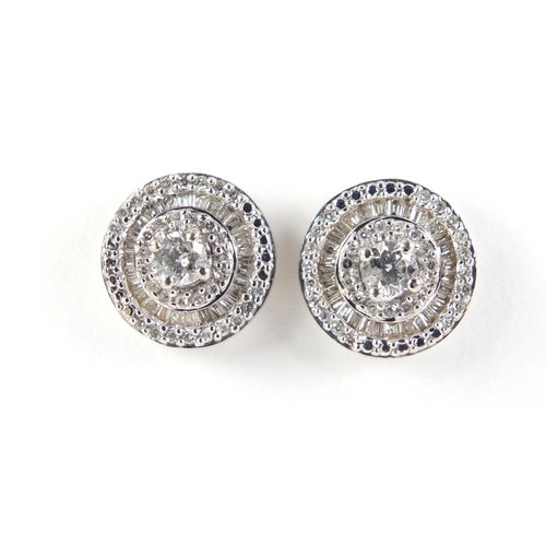 3423 - Pair of 10ct white gold diamond halo earings, 1.1cm in diameter, 2.8g