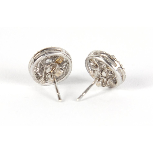 3423 - Pair of 10ct white gold diamond halo earings, 1.1cm in diameter, 2.8g
