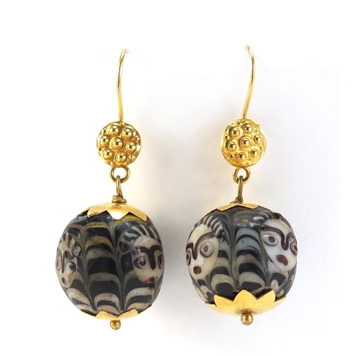 3820 - Pair of Islamic unmarked gold mounted glass earrings, hand painted with face masks, each 4.5cm in le... 