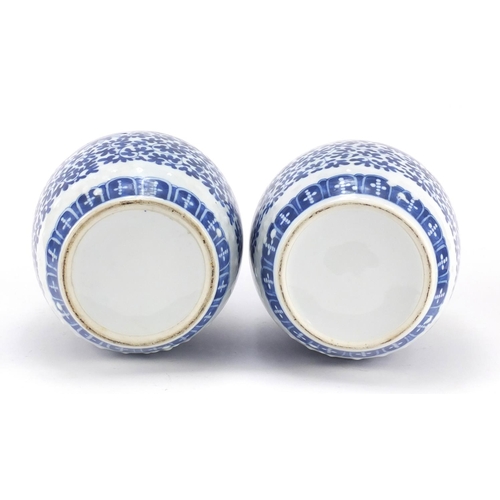 3042 - Pair of Chinese blue and white porcelain jars and covers raised on hardwood stands, each hand painte... 