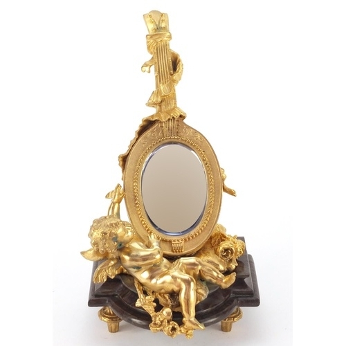 4003 - French Empire style gilt bronze table mirror in the form of putti with a mandolin, raised on a shape... 