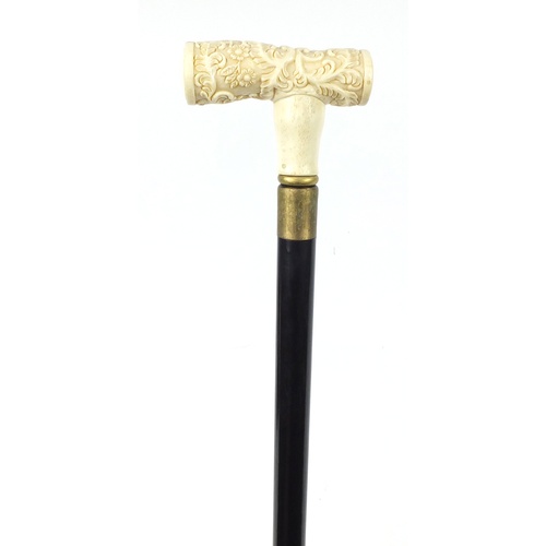 3564 - Hardwood walking stick having a bone handle carved with flowers, 92cm in length