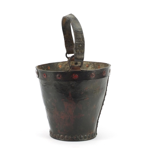 3175 - Antique leather fire bucket with metal rim and remnants of paint, 27cm high excluding the handle